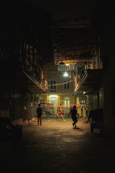 Street scene at night: football in the courtyard by NZME Photography