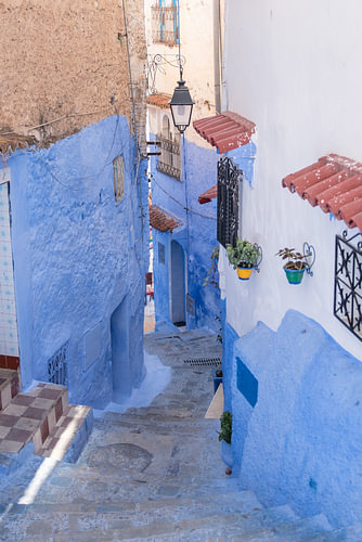 A pastel blue staircase with terracotta in Morocco