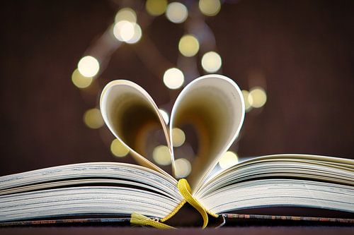 Heart pages in a book with light dots