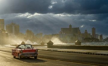 A classic car on the Malecon on a cloudy day