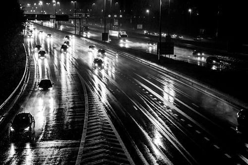 Morning rush hour in the dark on the motorway, during snowfall