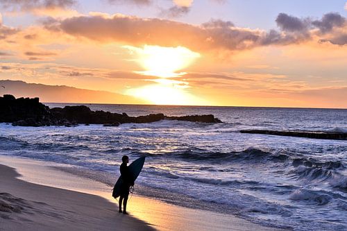 Surfing at sunset.