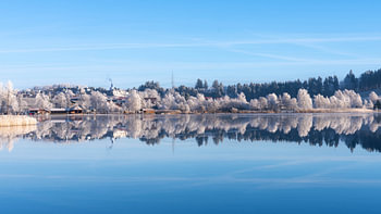 A frosty day at Weissensee in Bavaria’s Allgäu region, Germany, with a lovely sunny winter atmosphere