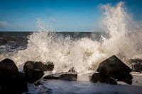 The waves break on the basalt blocks on the North Sea