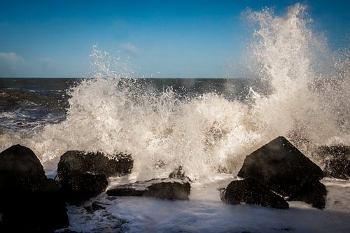The waves break on the basalt blocks on the North Sea