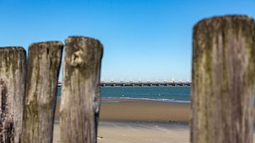 Beach posts with the Eastern Scheldt storm surge barrier by Percy's fotografie