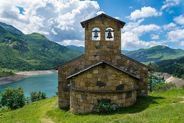 Church at a blue mountain lake in France by Linda Schouw