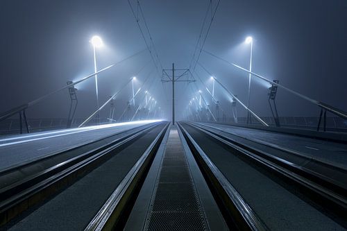 On the Erasmus Bridge in Rotterdam in the fog by Rob van der Teen