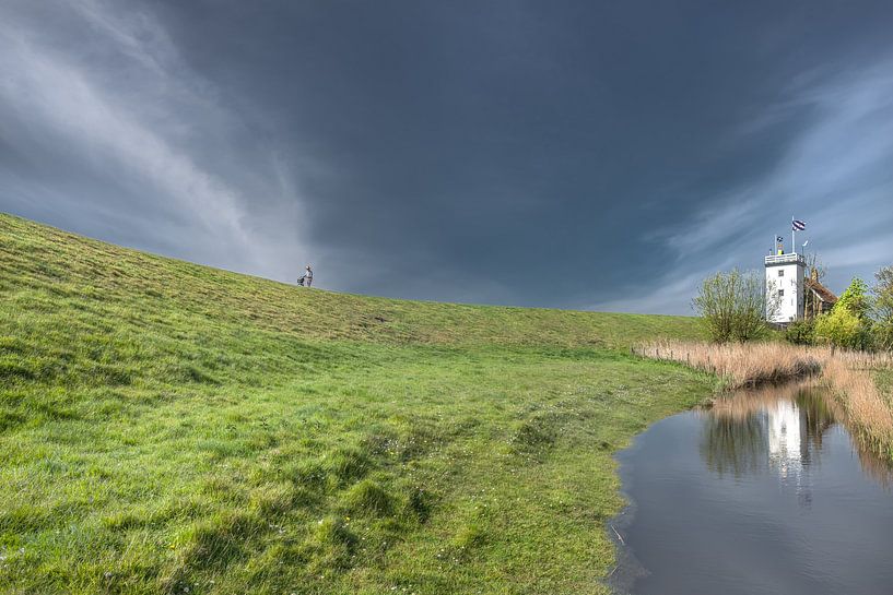 The old Workum lighthouse mirrored in a ditch by Harrie Muis
