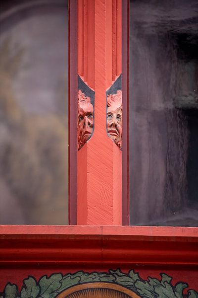 Heads on window of Basel Town Hall in Switzerland by Joost Adriaanse