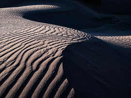 Abstract interplay of lines in the Sahara. Sand dune in the desert