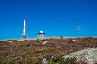 Contrast between human engineering and natural beauty with the Orange-White transmitter mast on the iconic Brocken
