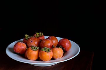 Persimmon in plate by Ulrike Leone