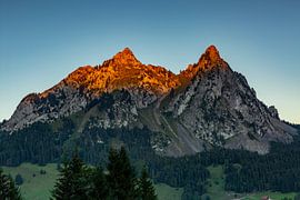 The Schwyz mountains Grosser and kleiner Mythen in Central Switzerland shine with alpenglow by Martin Steiner