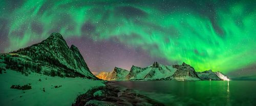 Panorama of Aurora over Tugeneset rocky coast with Kliptinden mountains in background, Senja,, Norwa