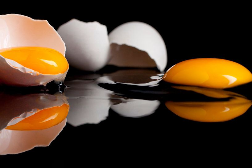 Rauwe eieren op een zwart gespiegelde plaat van Henny Brouwers
