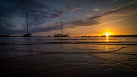 Boats on the horizon in the setting sun by piet douma