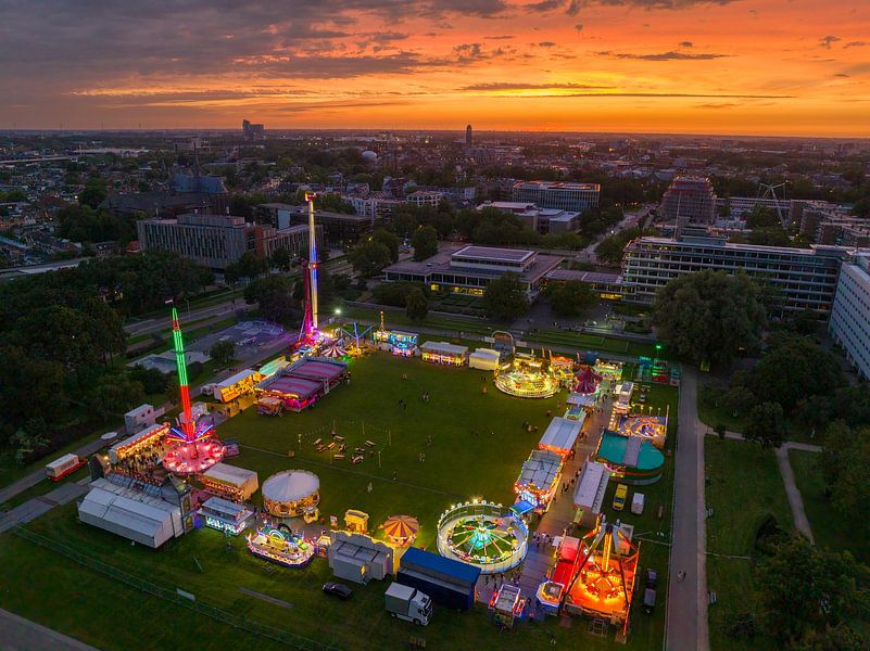 Fair during sunset with illuminated fairground attractions by Sjoerd van der Wal Photography