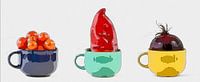 Three cups with vegetables