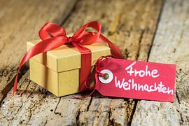Christmas present with tag german text, Frohe Weihnachten by Alex Winter