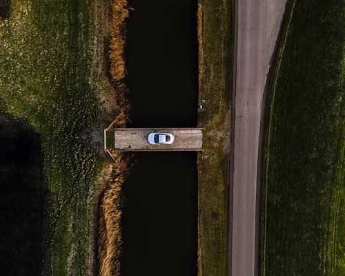 Auto op brug boven donkere Friese vaart