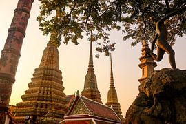Mosaic tiled Buddha stupas and an iron sculpture at Wat Pho temple. by kall3bu