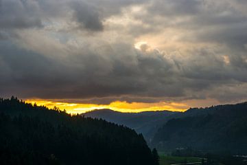 Intense orange sunset in the middle of the black forest near Fre by adventure-photos