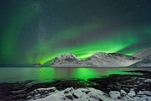 Aurora borealis above a winter mountain range