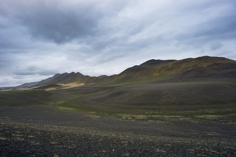 Iceland - Scraggy lava mountain chain and some green moss by adventure-photos