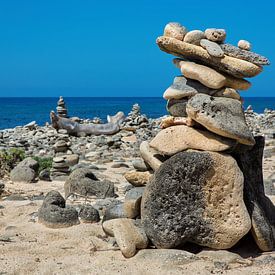 Stacked boulders as a symbol on the coast of the island of Bonaire by Ben Schonewille