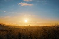 Zonsopkomst boven de duinen en het helmgras bij Bergen aan Zee