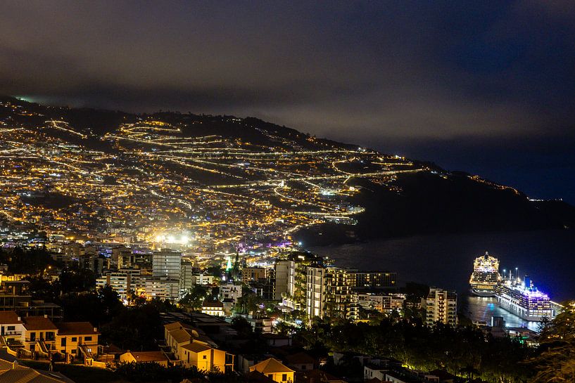Funchal in Madeira in the early evening with illuminated cruise ship and lights in the city by Eric van Nieuwland