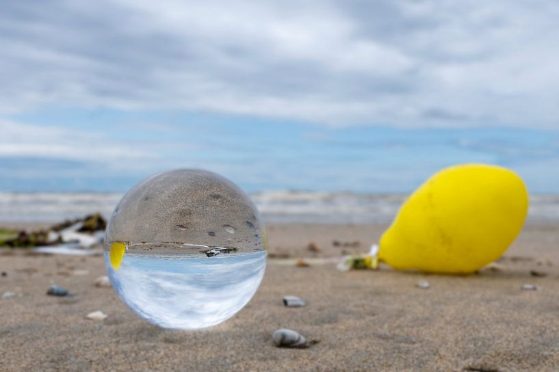 Lens ball on the North Sea beach by Peter Bartelings