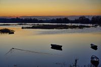 High tide Ooijpolder with boats and duck in the setting sun