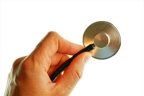 Stethoscope in one hand for a hospital atmosphere.
