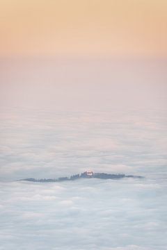 Church of St. George near Bernbeuren in Bavaria above the clouds at sunrise. Taken from the Ammergau