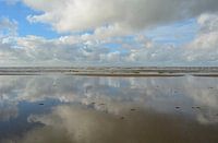 Reflection of clouds in water of the North Sea.