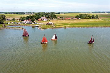 Luchtfoto van traditionele houten schepen op het IJsselmeer bij de haven van Laaxum in Friesland Nederland van Eye on You