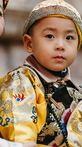 Portret van een kind in traditionele ceremoniële kleding, gefotografeerd in Beijing, China,