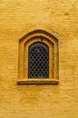 Church window in ochre wall. by Axel Weidner thumbnail