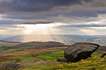 Sonnenstrahlen durch die dunklen Wolken im Höchstbezirk, Großbritannien