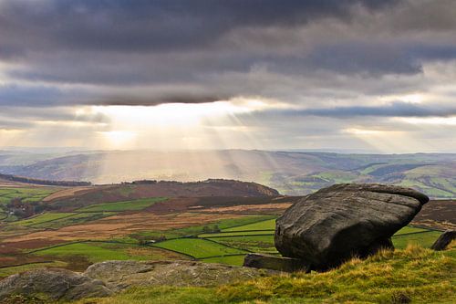 Sun rays through the dark clouds at Peak District, United Kingdom
