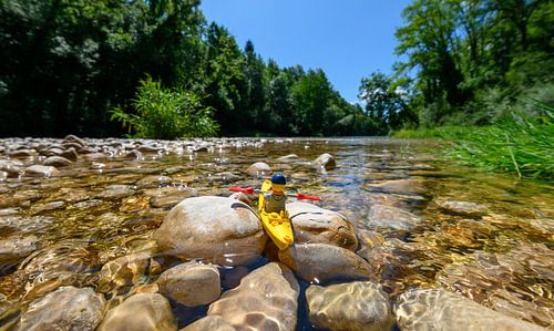 Lego puppet in natural landscape with canoe