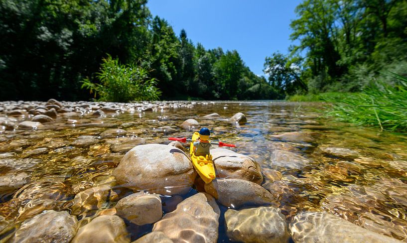 Lego puppet in natural landscape with canoe by Michel Knikker