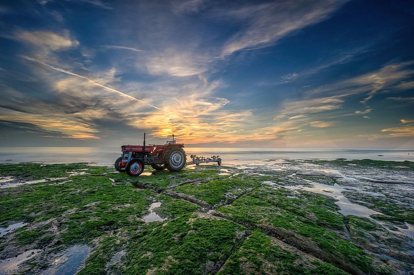 Tractor on the beach; fishing boat has sailed out again. by Leon Okkenburg