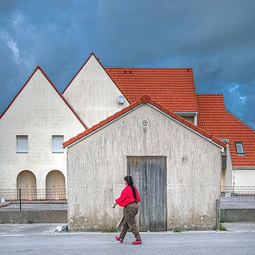 Houses in the French seaside resort of Wissant with a single walker in the foreground by Harrie Muis
