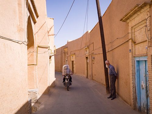 Motorcyclist and old man on the streets of Yazd, Iran