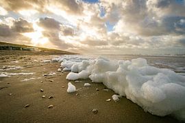 Sea foam on a North Holland beach during a stormy winter morning by Arthur Puls Photography