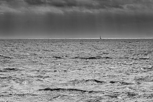 One boat. One streak of light. Everything else: storm.