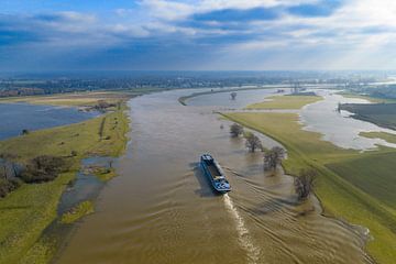 Freight ship sailing on the IJssel river with high water level o by Sjoerd van der Wal Photography